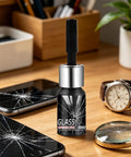 Scratch Repair Liquid For Glass Surfaces Quick Fix On The Go Clear Cracks And Scratches From Windscreens Watches Glasses And Home Screens With Portable Glass Repair Fluid bottle on desk with cracked phone screens and watch