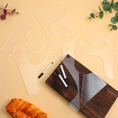 Slick Clear Acrylic Charcuterie Board Templates Kit With Three Woodworking Pens on a wooden cutting board with a loaf.