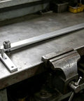 Built Like A Tank Manual Rebar Bender And Mini Pipe Tool Heavy Carbon Steel Benchtop workhorse on a metal table.