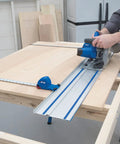 Person using Adaptive Cutting System Parallel Guides For Track Saws ACS415 for precise straight cuts in woodworking.