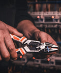 Person using Heavy Duty 8 In 1 Linesman Pliers For Electrical DIY Projects Wire Cutter Crimper Stripper Twist Deburr Winding And More Go To