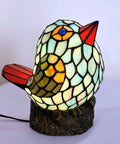 Bird themed glass nightstand lamp with blue green stained shade on resin base
