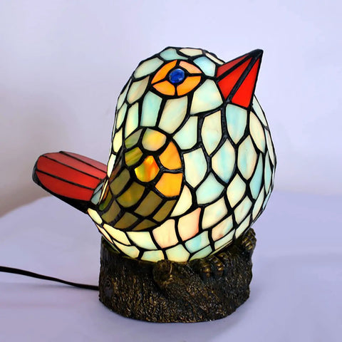 Bird themed glass nightstand lamp with blue green stained shade on resin base