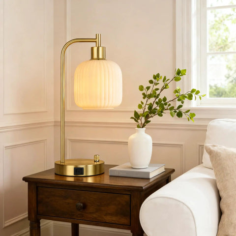 Industrial Touch Control Desk Lamp With Dual USB Ports And Outlet next to a vase on a wooden nightstand in a living room.