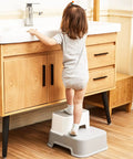 Child using Two Step Toddler Stool Set Of Two at sink, light grey color, easy access for potty training and washing.