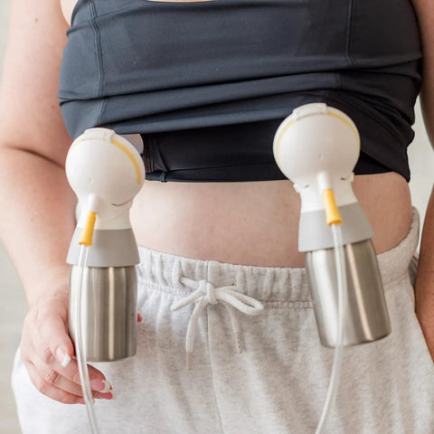 Roll Ready Six Oz Stainless Steel Breastmilk Bottle With Direct Pump Setup attached to a pumping device on a nursing mother.