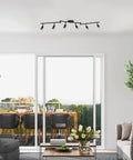 Six Light Foldable Track Lighting Kit With Adjustable Heads And Bendable Arms In Matte Black Finish above living room setting