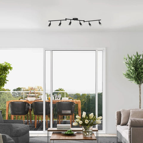 Six Light Foldable Track Lighting Kit With Adjustable Heads And Bendable Arms In Matte Black Finish above living room setting