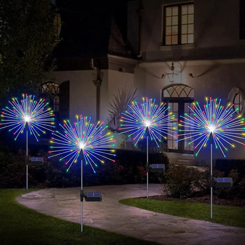 4 Pack Solar Garden Lights With 120 LED Starburst Effects illuminating a courtyard, showing colorful lights and solar panels at night.