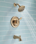 Lahara 17 Series Dual-Function Tub And Shower Trim Kit With 5-Spray Touch-Clean Shower Head In Stainless Steel against a tiled wall
