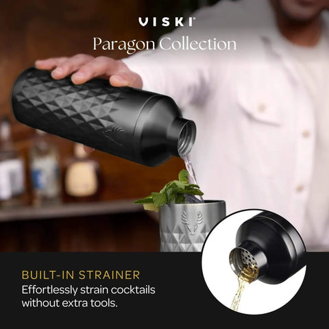 Person pouring drink from Paragon Vacuum Insulated Cocktail Shaker with built-in strainer into a glass, home bar background.