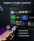 Person holding remote control in front of screen with streaming apps showcasing Outdoor 4K Projector With Built In Google TV And Voice Control