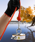 Double Sided Magnetic Fishing Kit With Beast 2600 Lb Pull, 100 Ft Rope in hand near a lake with autumn trees