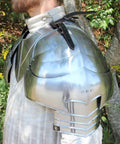 Close-up of Medieval 18 Gauge Steel Avenger Pauldrons Set With Genuine Leather Straps And Neck Harness on model's shoulder.