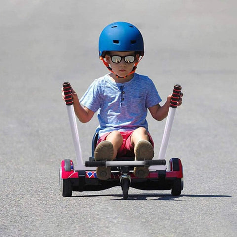 Child riding Hoverboard Seat Attachment Go Kart Conversion Kit For Self Balancing Scooters, red frame on a paved path.