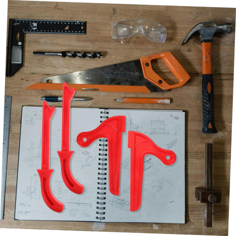 Four piece table saw push stick and block set in red on workbench with tools and sketchbook for ergonomic hand safety and precision cuts