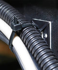 Heavy Duty Self Adhesive Zip Tie Mounts Kit in use with 8-inch zip tie securing cables to wall using adhesive mounting base and screw