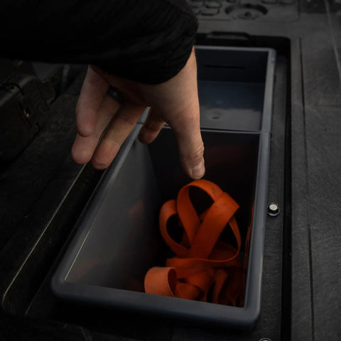 Deep Stash Bins Compatible With The New Drawer System being used to store orange gear in a truck decked drawer