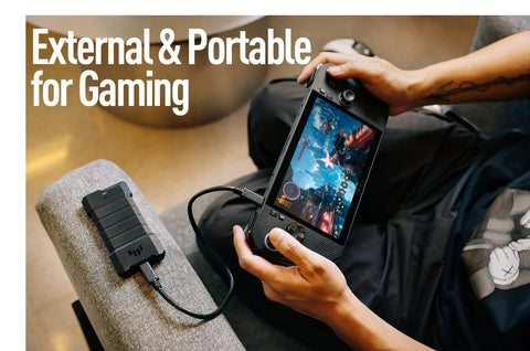 Person gaming with handheld device connected to TUF Gaming A2 USB C 3.2 Gen 2x2 Portable SSD Enclosure With Dual M2 NVMe PCIe And SATA