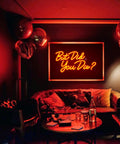 Red LED 'But Did You Die' neon sign for wall decor in a cozy room setting with plush seating and warm ambient lighting.
