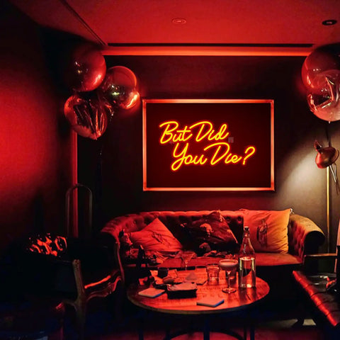 Red LED 'But Did You Die' neon sign for wall decor in a cozy room setting with plush seating and warm ambient lighting.