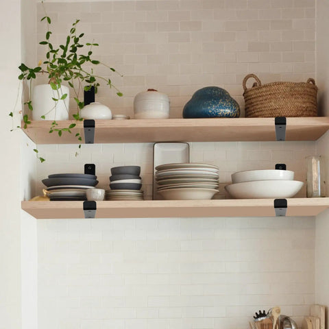 Matte Black J Lip Wall Shelf Brackets Hella Sturdy 8 Pack used to support wooden shelves with dishware and plants.