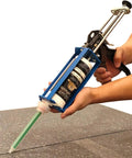 Hands using Heavy Duty All Metal Adhesive Dispenser Gun For 250mL Cartridges, 2 Part Epoxy, 10:1 Mix Ratio, 25:1 Mechanical Advantage