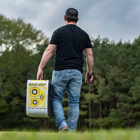 Person carrying 4 Sided Archery Target For Field Points And Broadheads, Open Face Layered Design With Friction Stopping Arrows