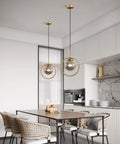 Dope Smoke Gray Glass Globe Pendant Light With Gold Rim in a modern kitchen setting, above dining table for versatile lighting.