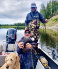 Two men on a boat showing a find using Beefy 1325 Lbs Large Magnet Fishing Kit With Double Sided Neodymium N52 Magnets, dog in foreground.