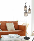 Dope Modern 3 Light Tree Floor Lamp With Crystal Birdcage Shades stands tall beside a brown sofa in an elegant living room setting.