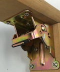 Close-up of golden folding table leg hinge with spring locking mechanism, mounted on wood. SPCC metal bracket for 90-degree position.