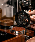 Hella Smooth 58mm Wdt Distribution Tool For Espresso Bars Featuring Ten Adjustable Needles Walnut Grip Dosing Funnel And Stand To Break Clumps And Nail That Daily Shot Like A Pro in use above ground coffee.
