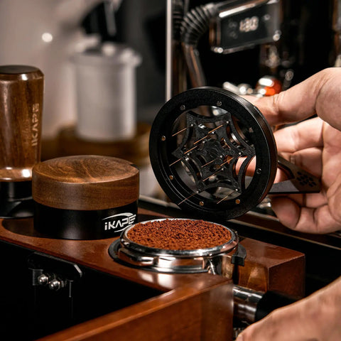 Hella Smooth 58mm Wdt Distribution Tool For Espresso Bars Featuring Ten Adjustable Needles Walnut Grip Dosing Funnel And Stand To Break Clumps And Nail That Daily Shot Like A Pro in use above ground coffee.