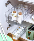 No Sweat Self Adhesive Drawer Slides Four Pack Slick Pull Out Cabinet Glides For Dresser Wardrobe And Home Office Setup With Heavy Duty Stick On Tape For Quick Diy Fix in a cabinet holding glasses and white containers.