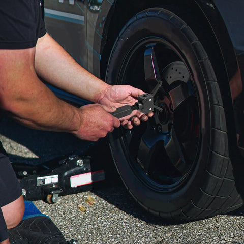 Using Heavy Duty Slide Hammer Bearing Puller Kit for quick knock loose of stubborn guide bearings on a vehicle wheel.