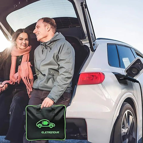 Couple by EV in trunk holding portable charger, showcasing Level Two EV Charger With 240V NEMA 14 To 50 Plug And 25 Foot Cable UL Certified.