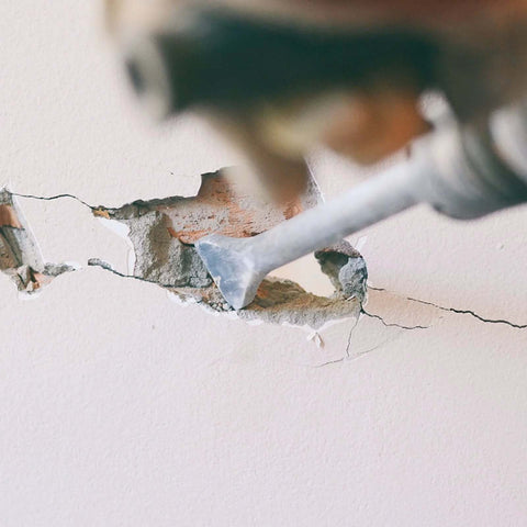 YOUGFIN SDS-Plus rotary hammer drill bit; carbide-tipped masonry bit in use on concrete wall