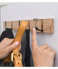 Wall Mounted Nailless Folding Coat Hook Set Featuring Twin Bar Design for Hallway Closet Entryway, person using a leather strap.