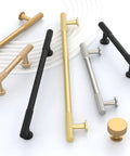 Assorted cabinet handles in champagne bronze, black, and silver finishes displayed on a white surface