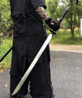 Person holding Hand Forged Longquan Style Dao Sword With High Carbon Steel Blade Full Tang And Dope Matte Black Wooden Scabbard