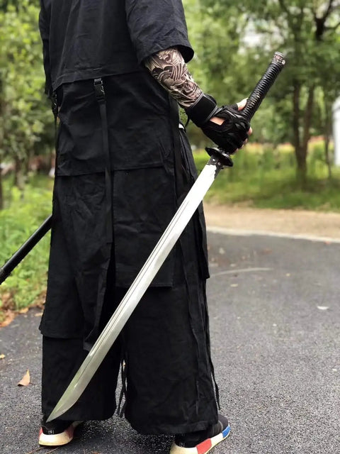 Person holding Hand Forged Longquan Style Dao Sword With High Carbon Steel Blade Full Tang And Dope Matte Black Wooden Scabbard