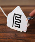 Plug And Play Smart Home Sensor Hub on wooden surface with LED indicators, showcasing easy touch control and sleek design.
