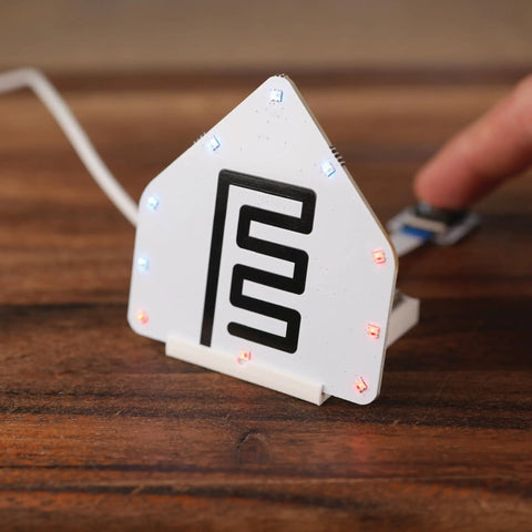 Plug And Play Smart Home Sensor Hub on wooden surface with LED indicators, showcasing easy touch control and sleek design.