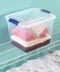 Heavy Duty Clear Storage Bins 2 Pack With Tight Blue Latches stacked on a shelf holding folded clothes.