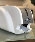 Ready To Roll Simplex ID Card Printer Kit Featuring Usb Camera, Premium Ymcko Ribbon, One Hundred Pvc Badges, And Straightforward Photo Capture Software For No Sweat Professional Printing - Smart 31 ID card printer on a desk