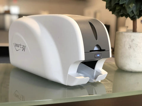 Ready To Roll Simplex ID Card Printer Kit Featuring Usb Camera, Premium Ymcko Ribbon, One Hundred Pvc Badges, And Straightforward Photo Capture Software For No Sweat Professional Printing - Smart 31 ID card printer on a desk