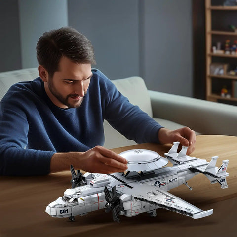 Man assembling E-2 Hawkeye Military Airplane Building Set 1126 Pieces For Adults And Teens Dope Fighter Jet Model Kit With Radar