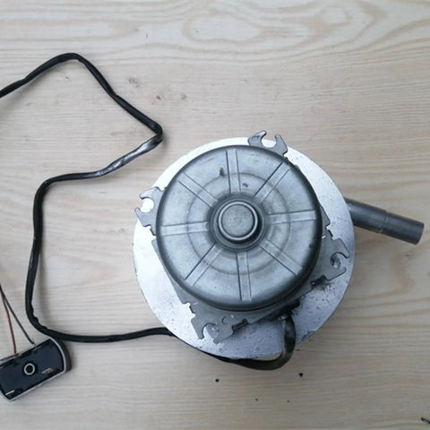 Top view of a Micro Hydro Generator 200W Portable Water Turbine Power For Home And Outdoor Adventures, with cables and pipe attached.