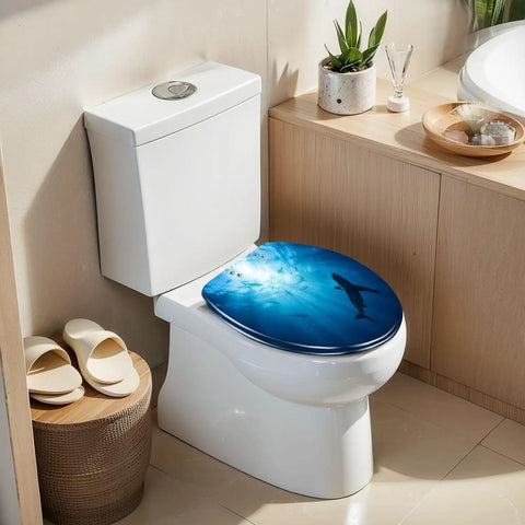 Elongated Silhouettes sharks underwater ocean against bright Toilet Seat on modern toilet with soft-close hinge.
